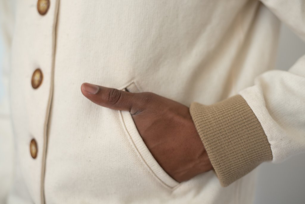 Car curtain canvas track jacket by Kali Made showing pocket and cuff details of white and brown cotton constructions
