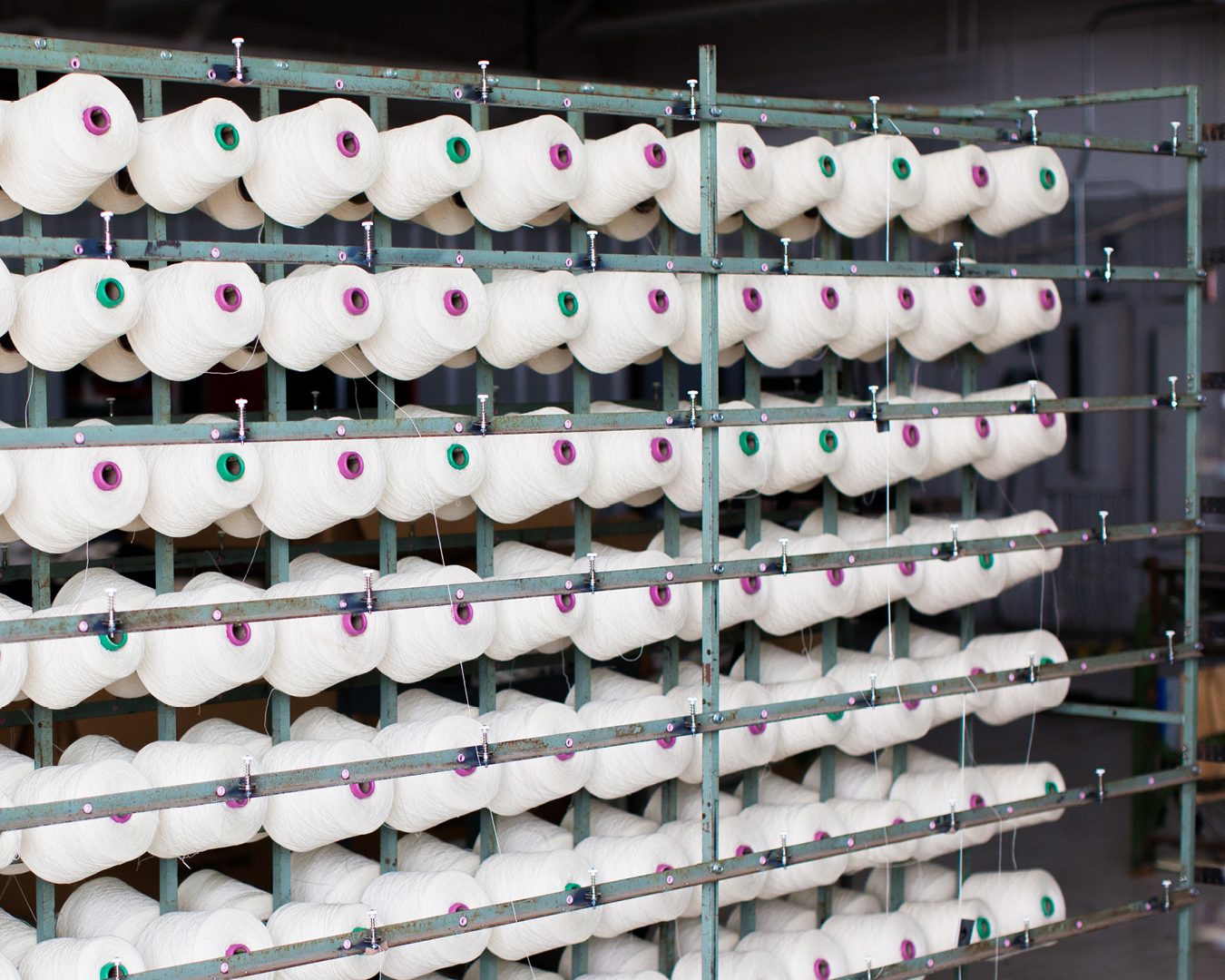 photograph-many-cones-of-yarn-on-metal-rack