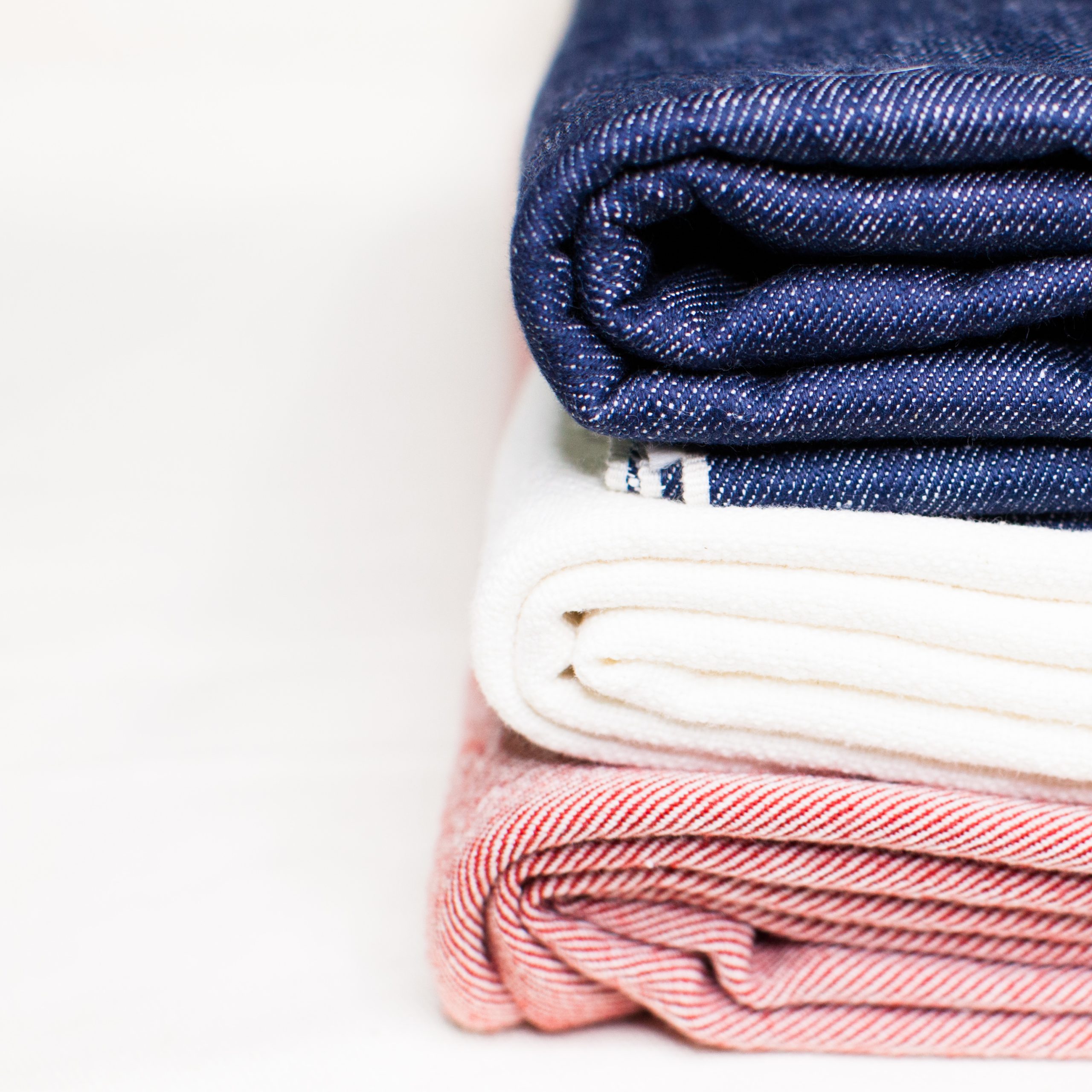 color-photograph-of-blue-white-red-selvedge-woven-textiles-stacked