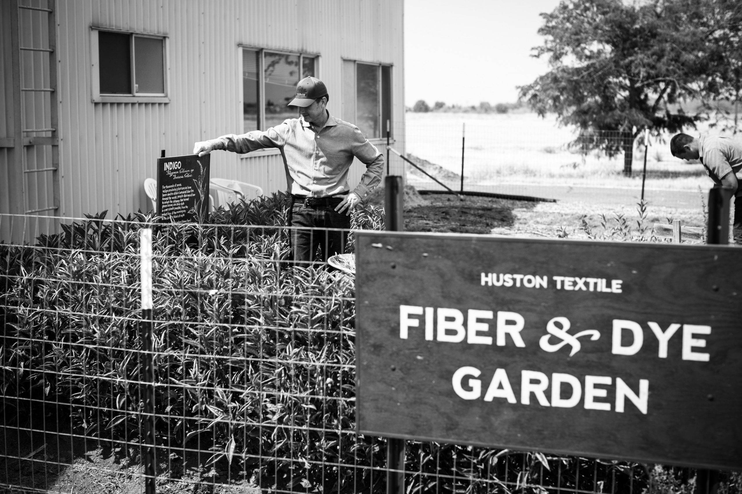 black-and-white-photograph-fiber-and-dye-garden-sign-and-garden-worker