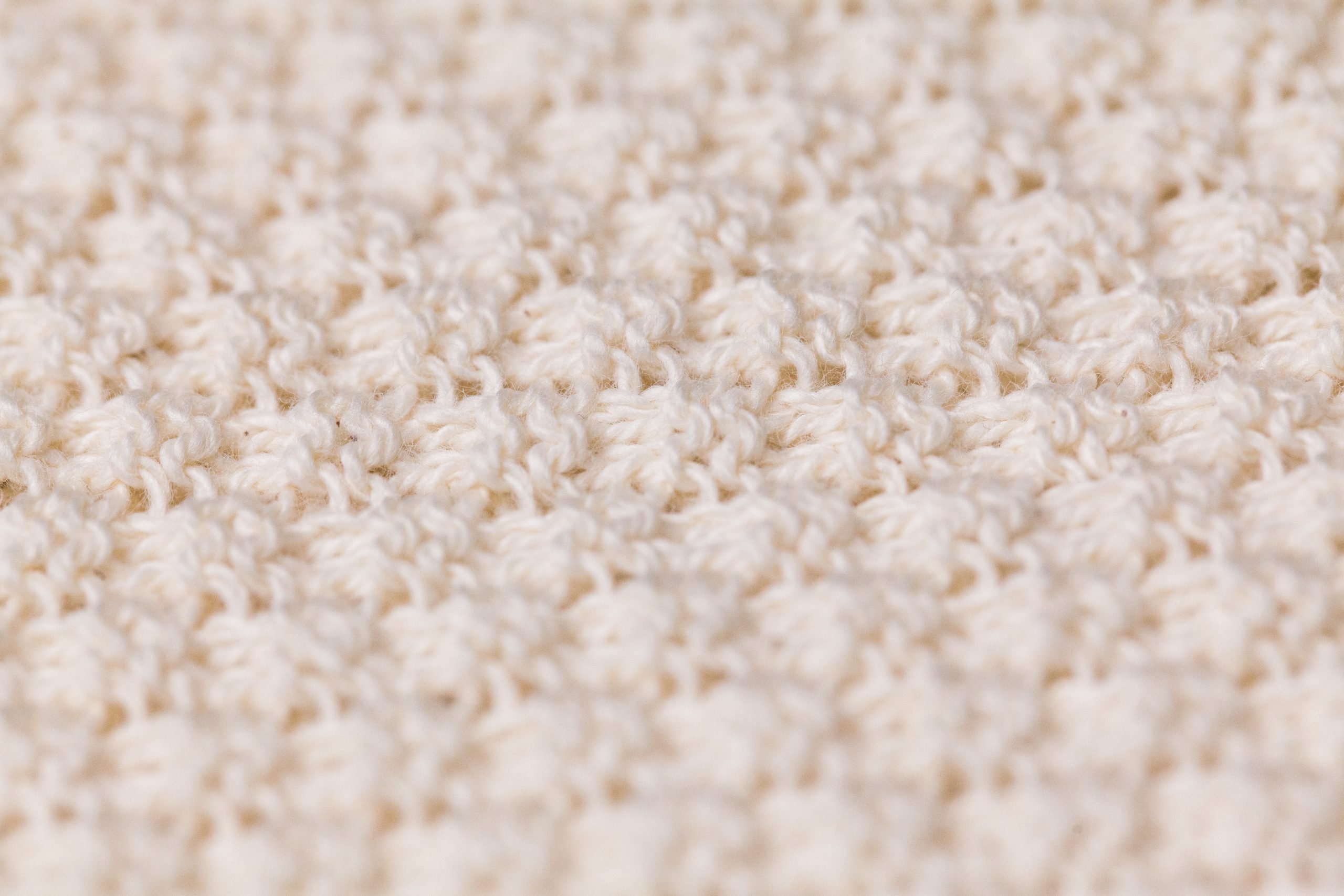 Detailed close up photograph of a moss-stitch Wholegarment produced fine knit wool swatch