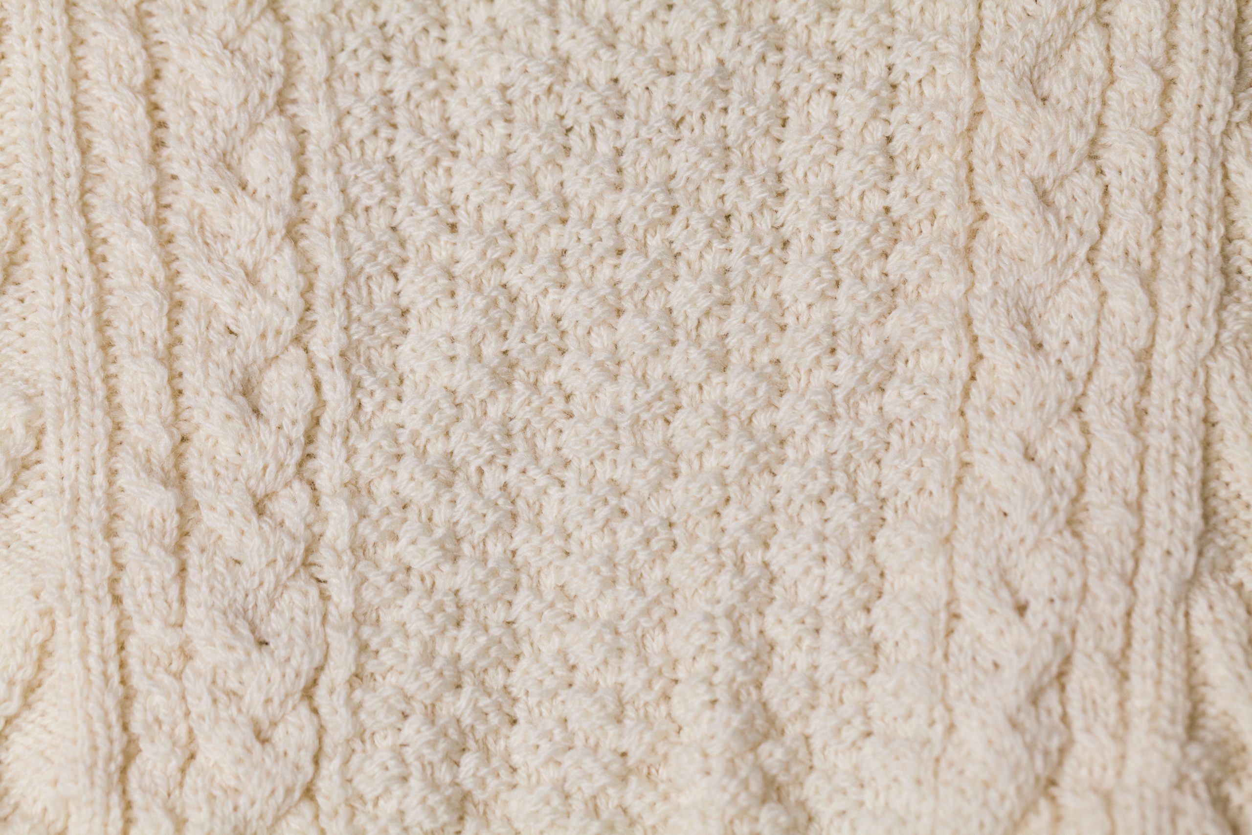 Detailed photograph of white wool fine knit textile produced on Shima Seiki Wholegarment machines